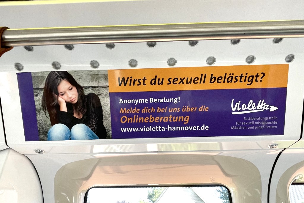 Standarddeckeninnenfläche in Stadtbahn bewirbt anonyme Beratung für sexuell belästigte Mädchen und junge Frauen.